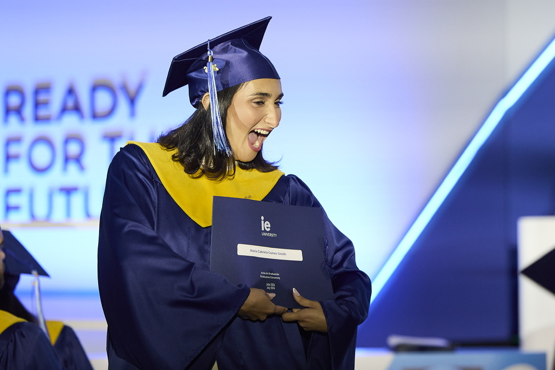 Gabi in cap and gown at her IE University master's graduation